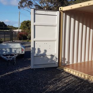 Trailer parked beside an open container